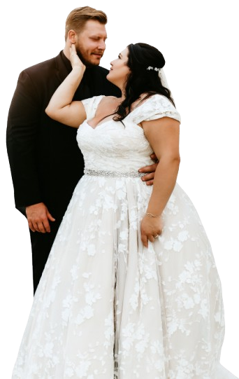 A couple in wedding attire, gazing at each other lovingly.